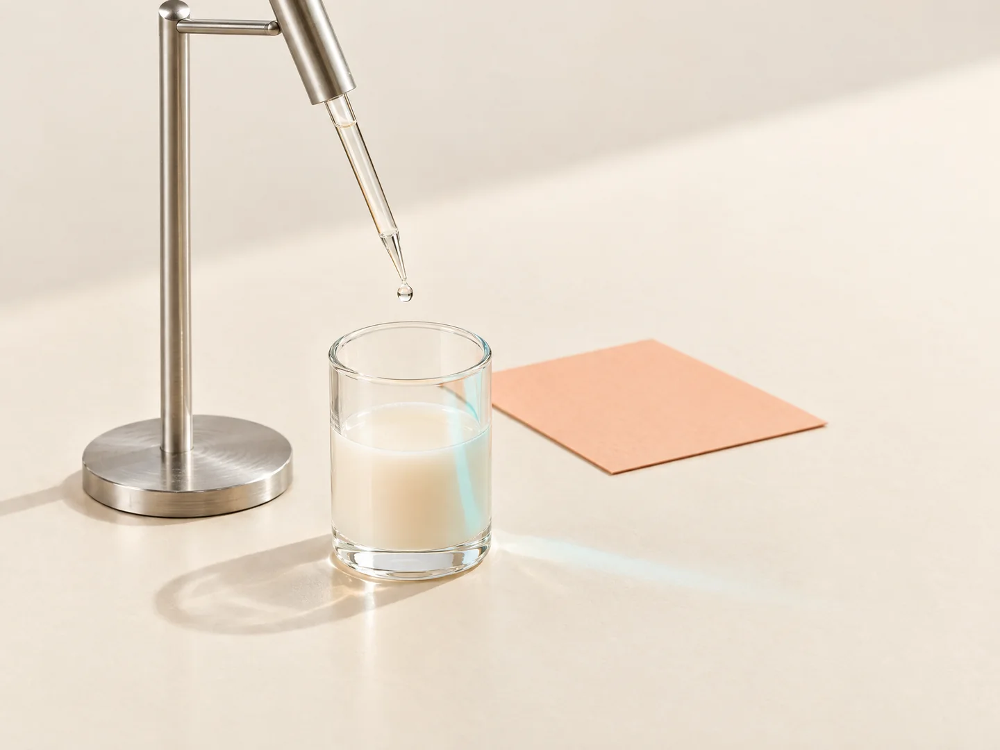 Conceptual product-development study with a pipette above a liquid sample