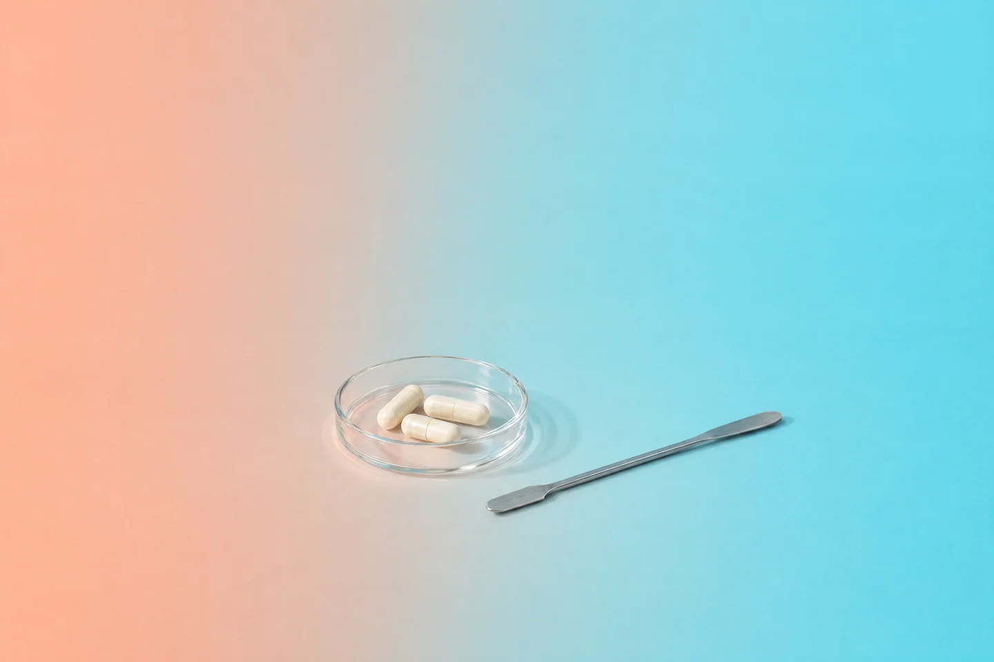 Minimal formulation study with glassware and supplement samples in peach and aqua tones