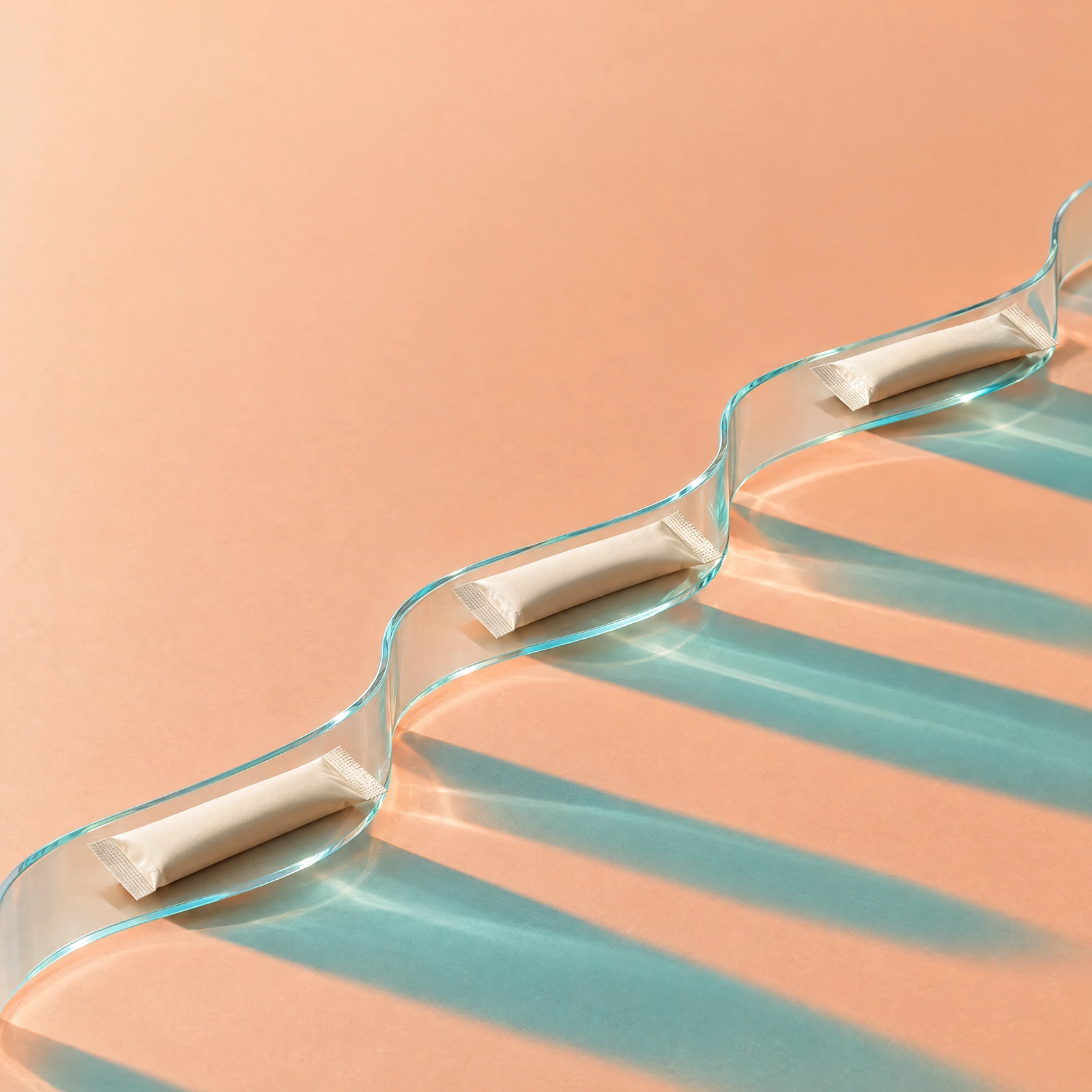 Three powder sticks along a curved clear-glass path